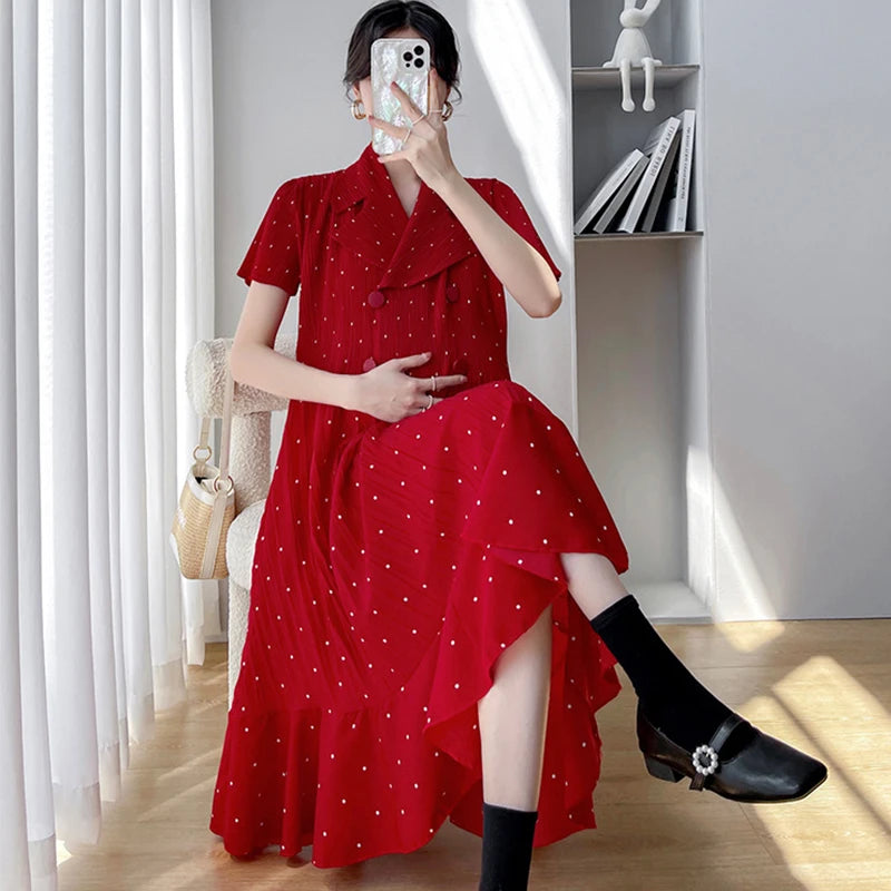 Red polka dot maternity dress featuring a high waist and mid-calf length, perfect for summer wear.