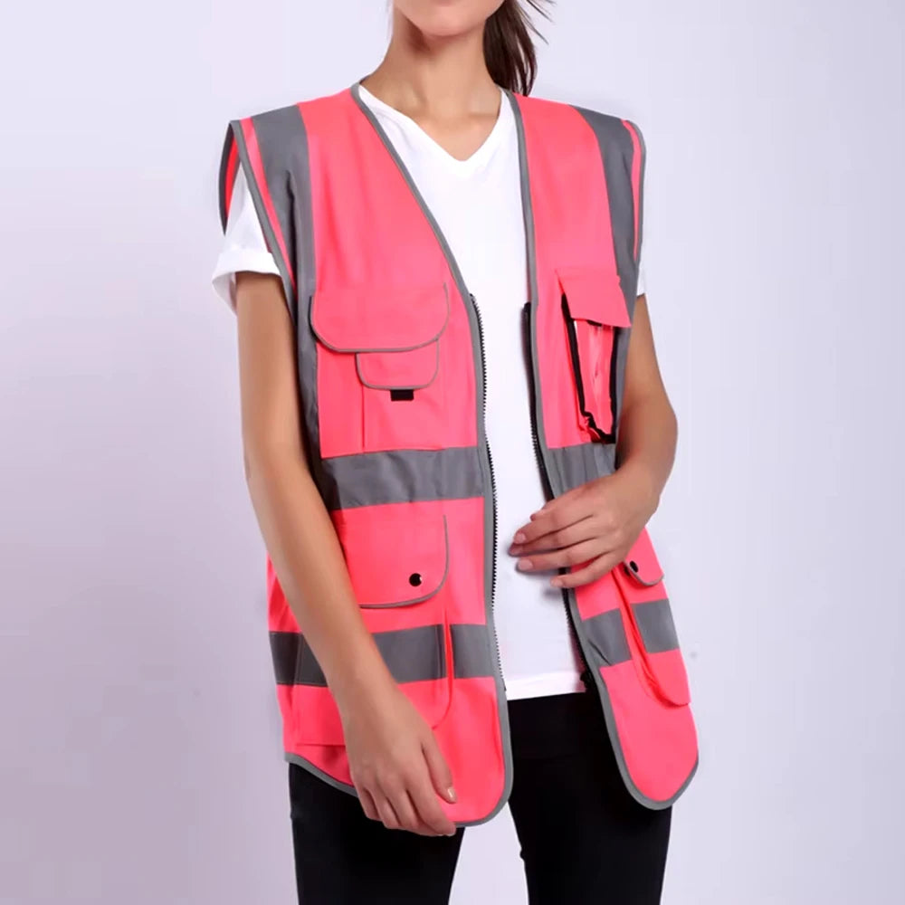 Hi-Vis pink safety vest with multiple pockets and reflective stripes for high visibility and durability in work environments.