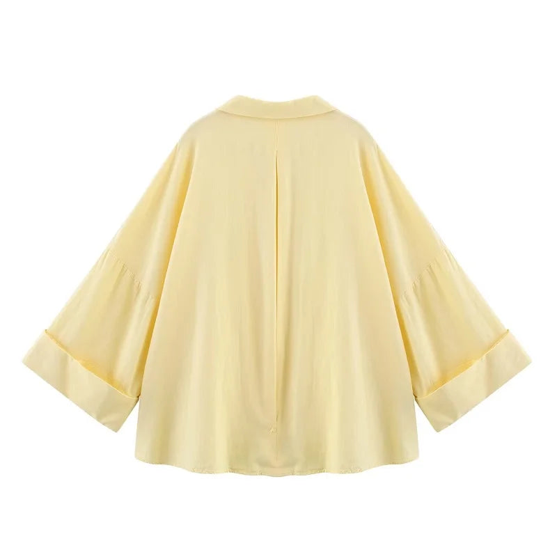Back view of WideLine™ oversized yellow striped shirt with loose fit and wide sleeves for summer casual wear.