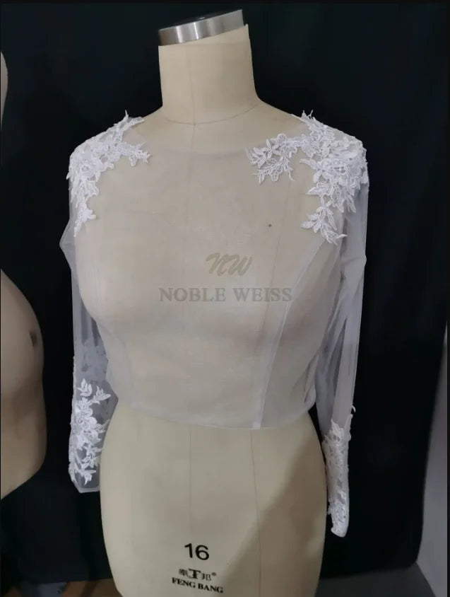 Elegant lace bridal bolero with long sleeves and scoop neckline, created by Noble Weiss, perfect for weddings.