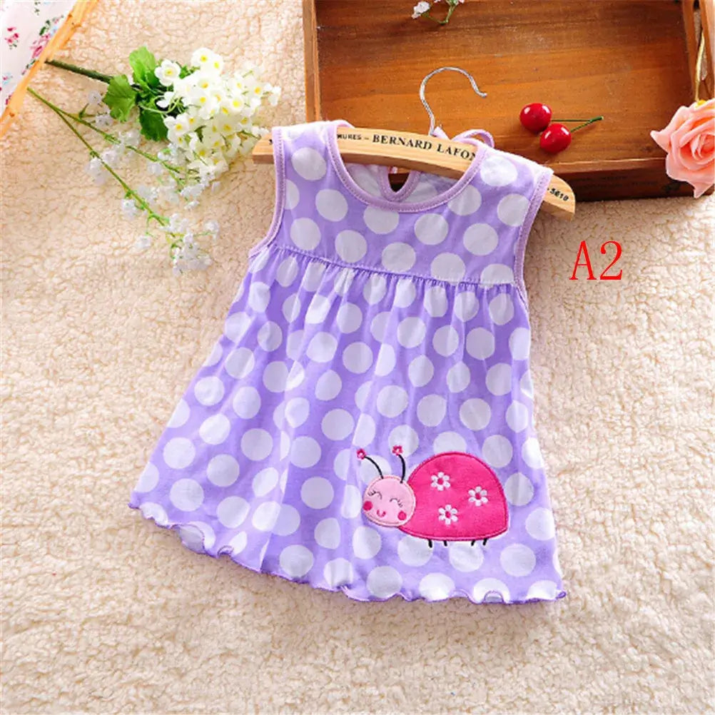 Newborn baby girls' cotton dress in lavender with polka dots and cute snail design, perfect for summer.
