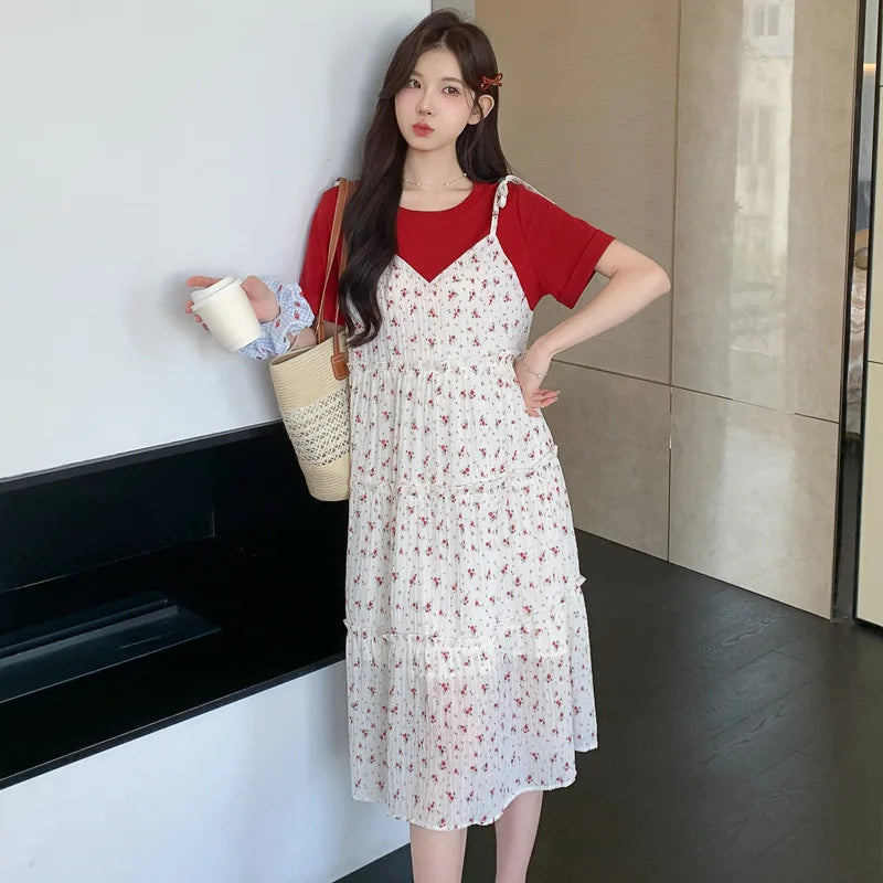 Model wearing a floral two-piece maternity skirt with contrasting colors, styled for summer fashion.