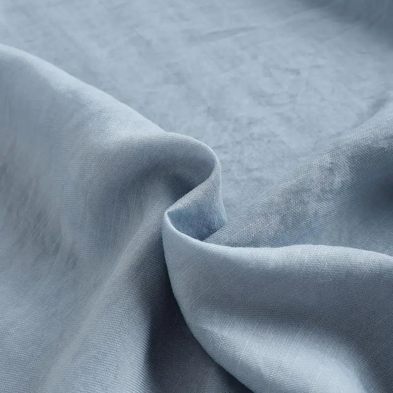 Close-up of soft blue fabric showcasing a luxurious texture for clothing.