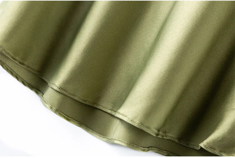 Close-up of elegant olive green satin fabric showcasing the soft texture and luxurious finish of the BandeauSilk™ camisole.