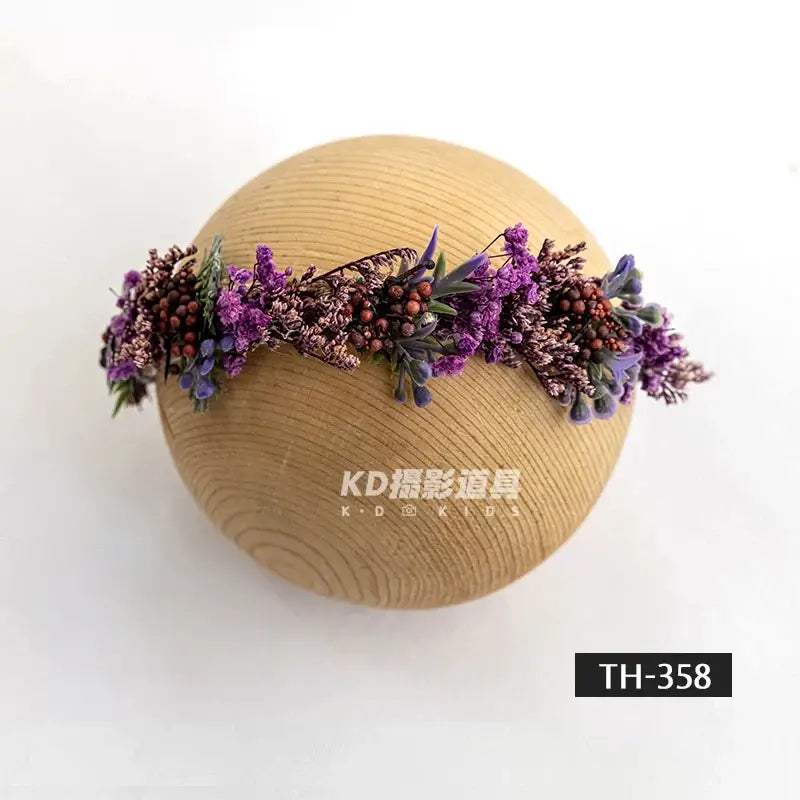 Purple faux flower headband for newborn photography, adjustable design for girls aged 0-6 months.
