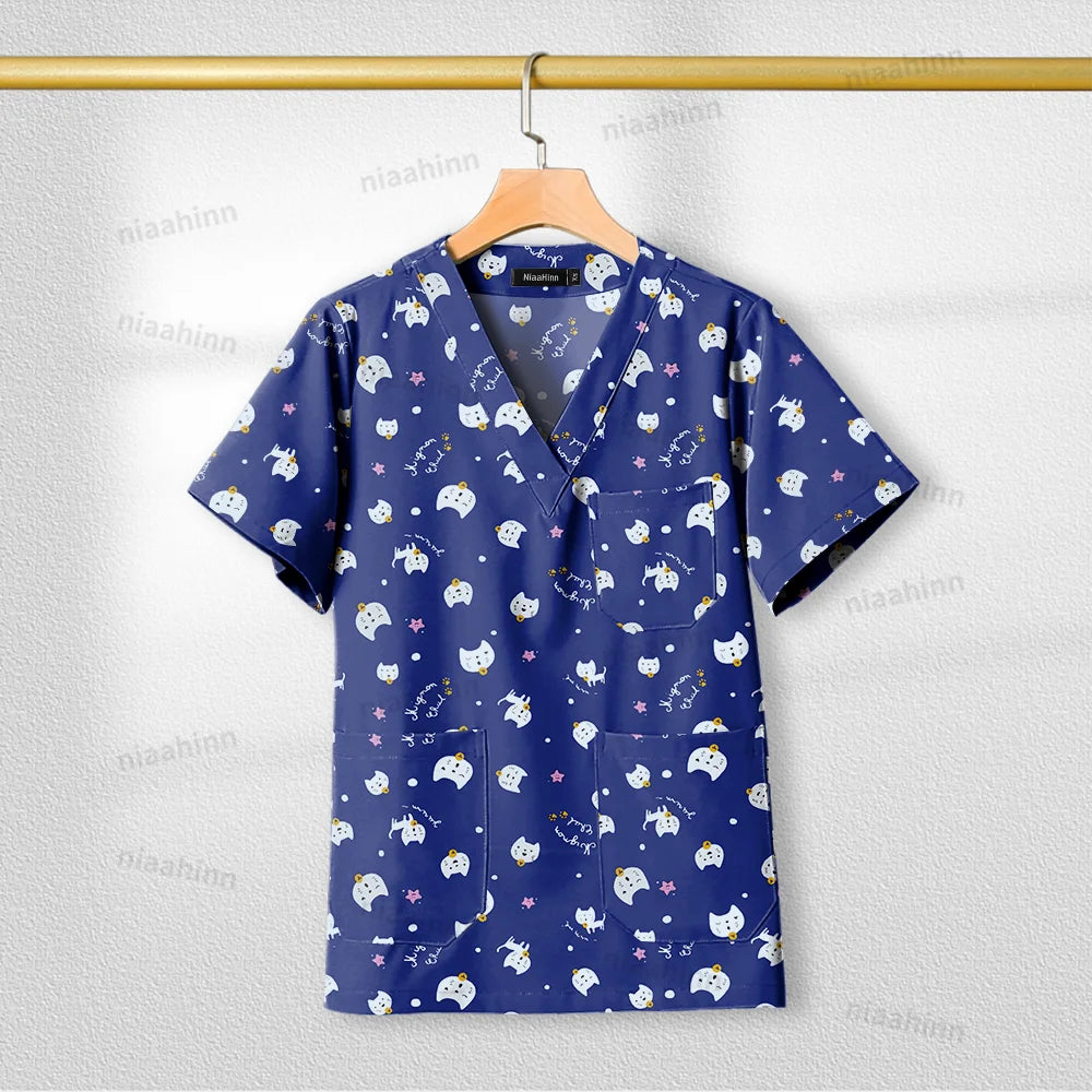 Printed nursing scrub top in navy with playful animal and star patterns, short-sleeve, breathable fabric for women.