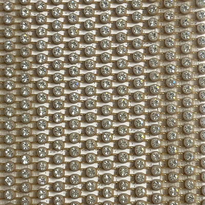 Close-up of sparkling rhinestone embellishments on a glamorous fabric, ideal for party attire and evening wear.
