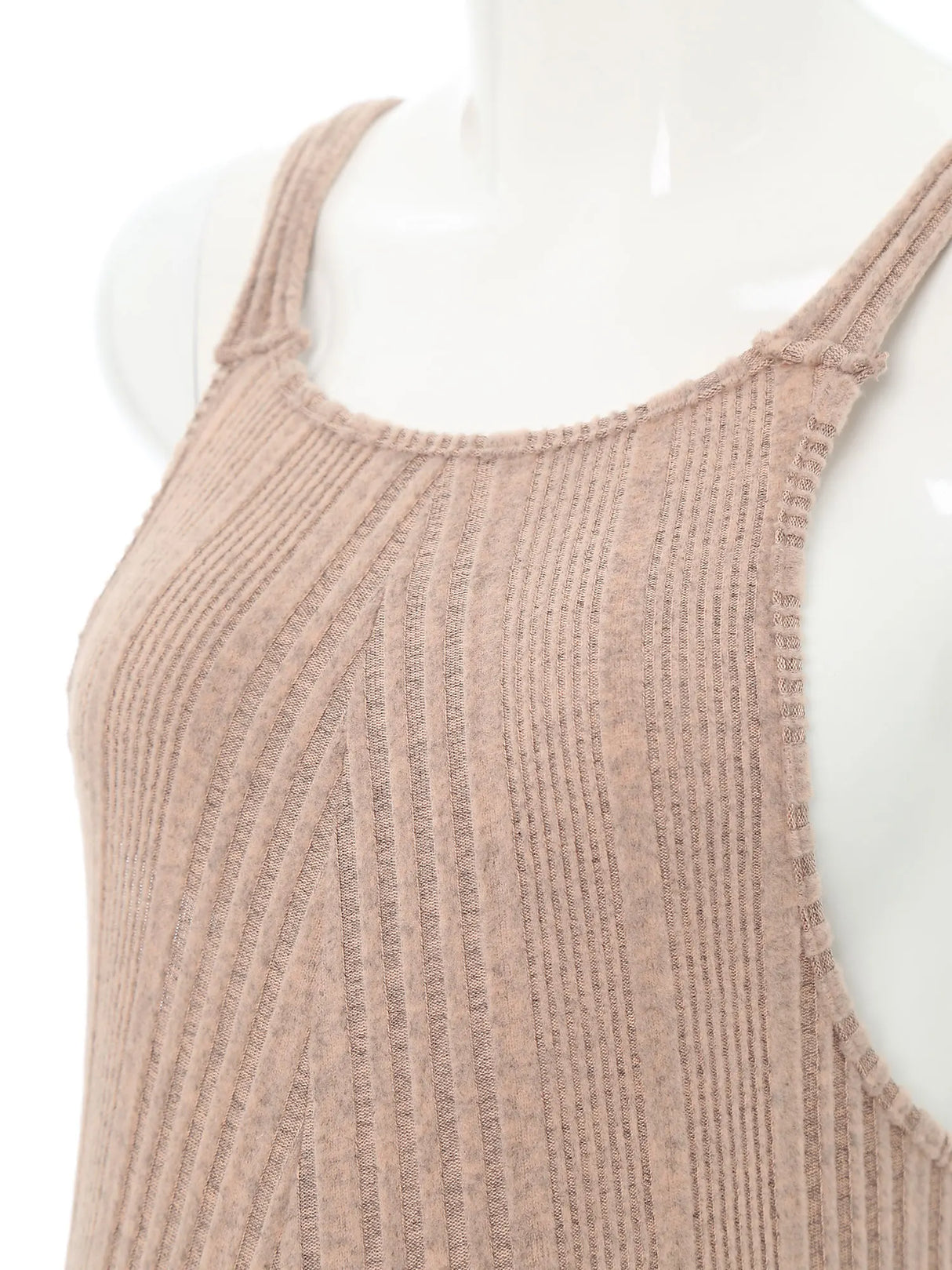 Close-up of sleeveless ribbed maternity jumpsuit fabric in neutral color, showcasing soft texture and comfortable fit.