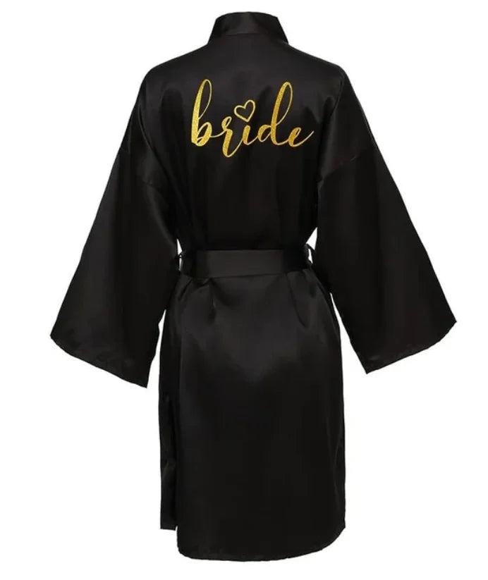 Black satin bride robe with gold lettering, perfect for wedding preparations and special occasions.