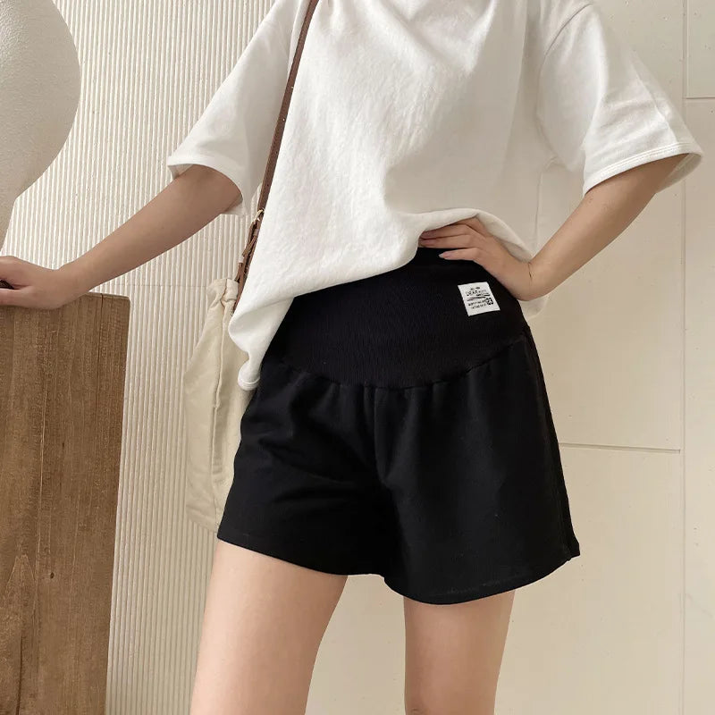Plus size adjustable maternity shorts in black, featuring a loose fit, ideal for summer wear for expectant mothers.