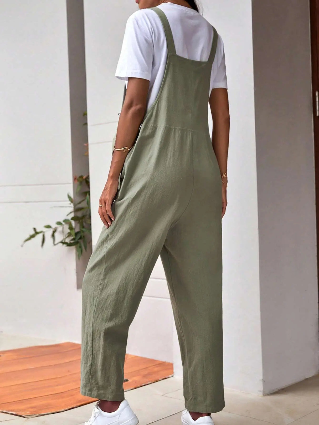 Adjustable maternity overalls in olive green, featuring a loose fit and bib design for women.