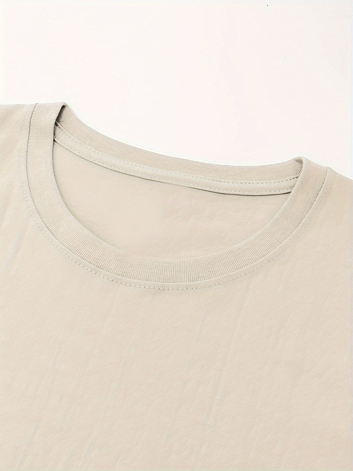 Close-up of a beige crew neck on a retro country music festival t-shirt made from 100% cotton.