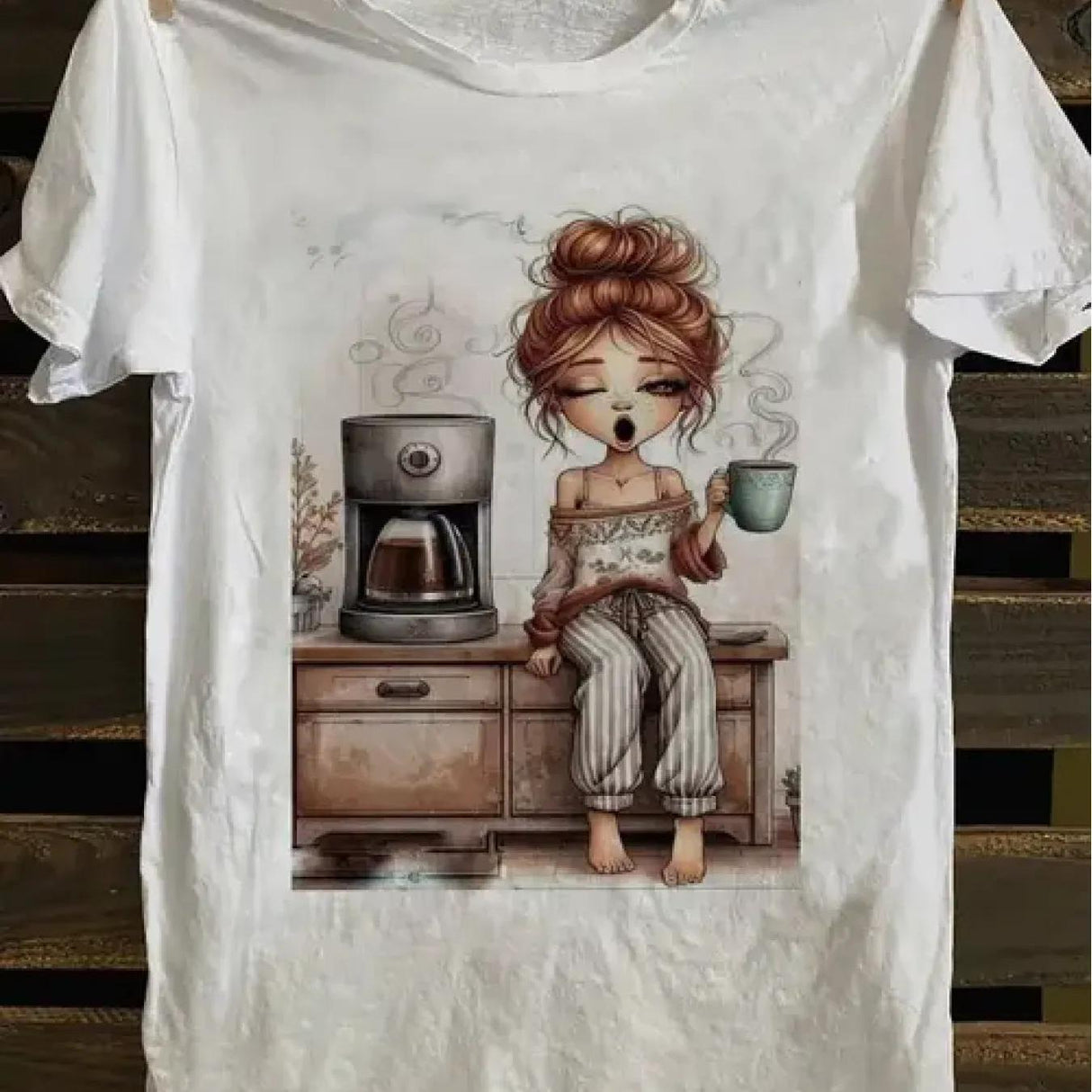 Summer casual coffee print t-shirt featuring a girl enjoying coffee in a cozy setting. Made of 100% cotton, micro elastic.