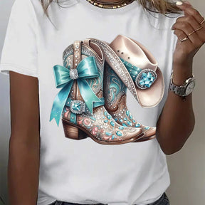 Stylish white t-shirt featuring a vibrant cowboy boots design with teal details and embellishments.
