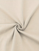 Close-up of soft beige cotton fabric, showcasing smooth texture and micro elasticity, ideal for casual clothing.