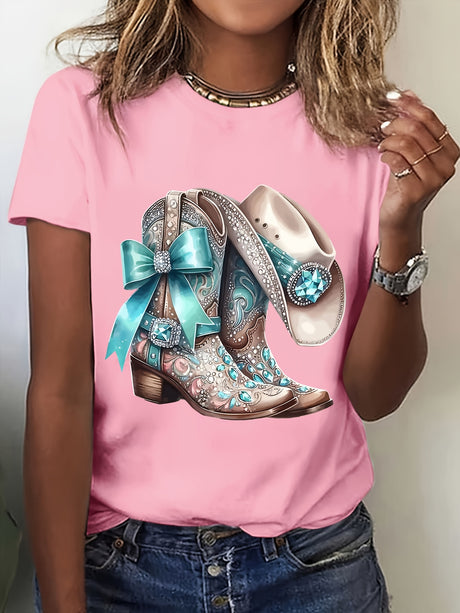 Woman wearing pink anime T-shirt featuring cowboy boots and hat design with turquoise accents and bow.