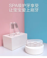 Transparent baby toothbrushes on display, featuring a modern design against a pastel background.