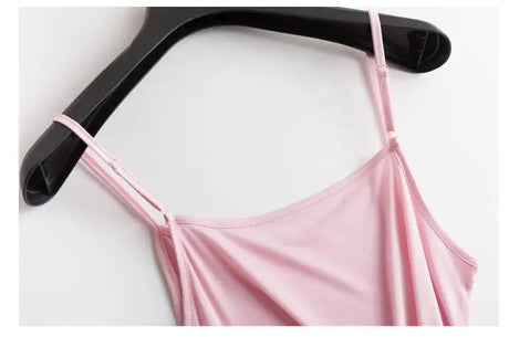 Close-up of a pink HalterSilk™ U-neck cami on a hanger, showcasing lightweight mulberry silk fabric and solid straps.