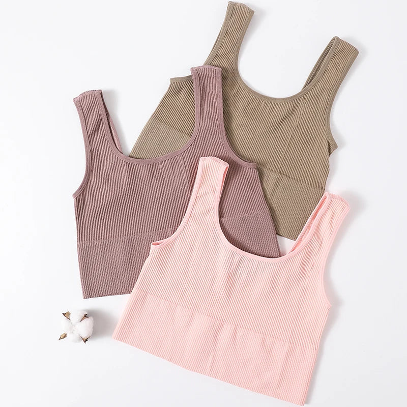 RibSculpt™ seamless ribbed camisoles in pink, brown, and tan on a white background.