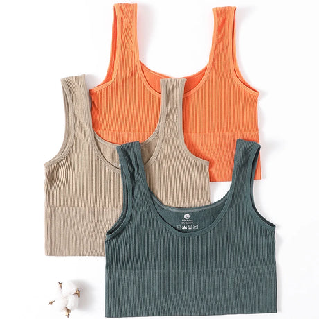 Three seamless ribbed camisoles in orange, beige, and green, perfect for women's fitness and casual wear.