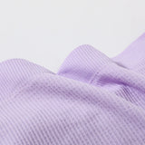 Close-up of soft lavender ribbed fabric for DeepVibe™ seamless crop top, showcasing texture and quality.