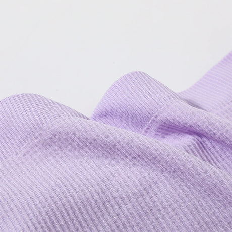 Close-up of soft lavender ribbed fabric for DeepVibe™ seamless crop top, showcasing texture and quality.