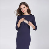 Model wearing a navy postpartum nursing maternity dress with 3/4 sleeves, designed for breastfeeding convenience.