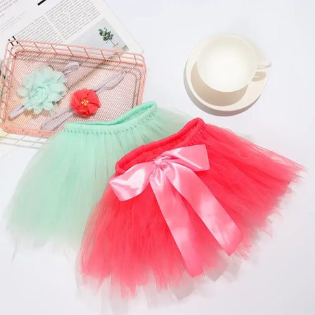Infant tutu skirts in mint green and bright pink with bows, perfect for baby girls' photography and costume needs.