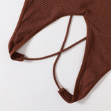 Detail of the MonoSculpt™ one-shoulder seamless crop top, showcasing ribbed texture and stylish strap design.