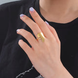 African map gold ring worn on a woman's finger, showcasing stylish design for daily wear and fashion.