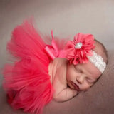 Sleeping baby girl in pink tutu skirt and headband set, perfect for photo shoots and newborn photography.