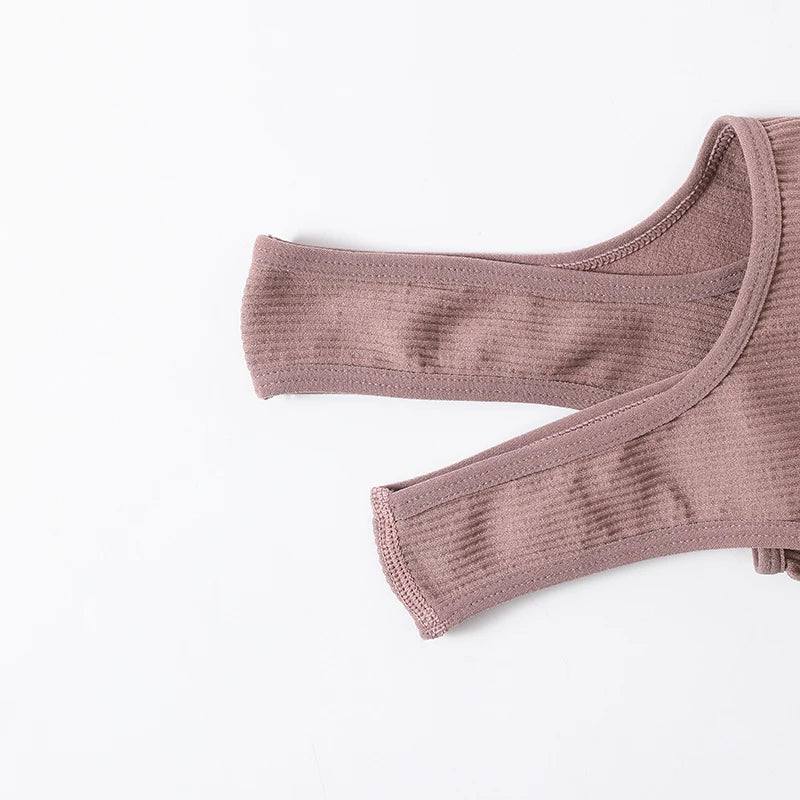 Close-up of seamless ribbed camisole straps in soft mauve, showcasing knit texture and wireless design.