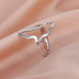 Stylish silver wave-shaped ring on soft pink fabric, perfect for women's daily fashion jewelry.