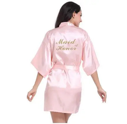 Light pink satin bridesmaid robe featuring 'Maid of Honor' text, perfect for elegant weddings.