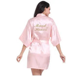 Light pink satin bridesmaid robe featuring 'Maid of Honor' text, perfect for elegant weddings.