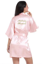 Light pink satin bridesmaid robe with 'Matron of Honor' embroidered on the back, perfect for elegant wedding celebrations.