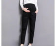 Casual black maternity pants on a model, featuring pockets and a straight fit, suitable for all seasons.