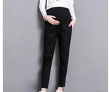 Casual black maternity pants on a model, featuring pockets and a straight fit, suitable for all seasons.
