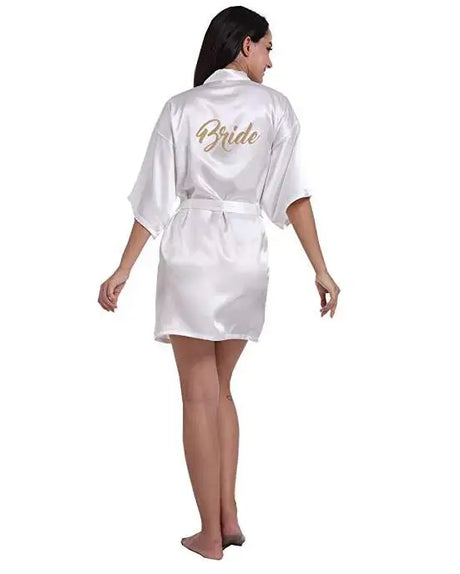 White satin robe for brides with 'Bride' written on the back, showcasing elegant wedding attire.