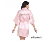 Light pink satin bridesmaid robe with elegant design, perfect for weddings and bridal parties.