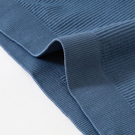 Close-up of ribbed blue fabric showcasing the seamless knit texture, perfect for stylish activewear.