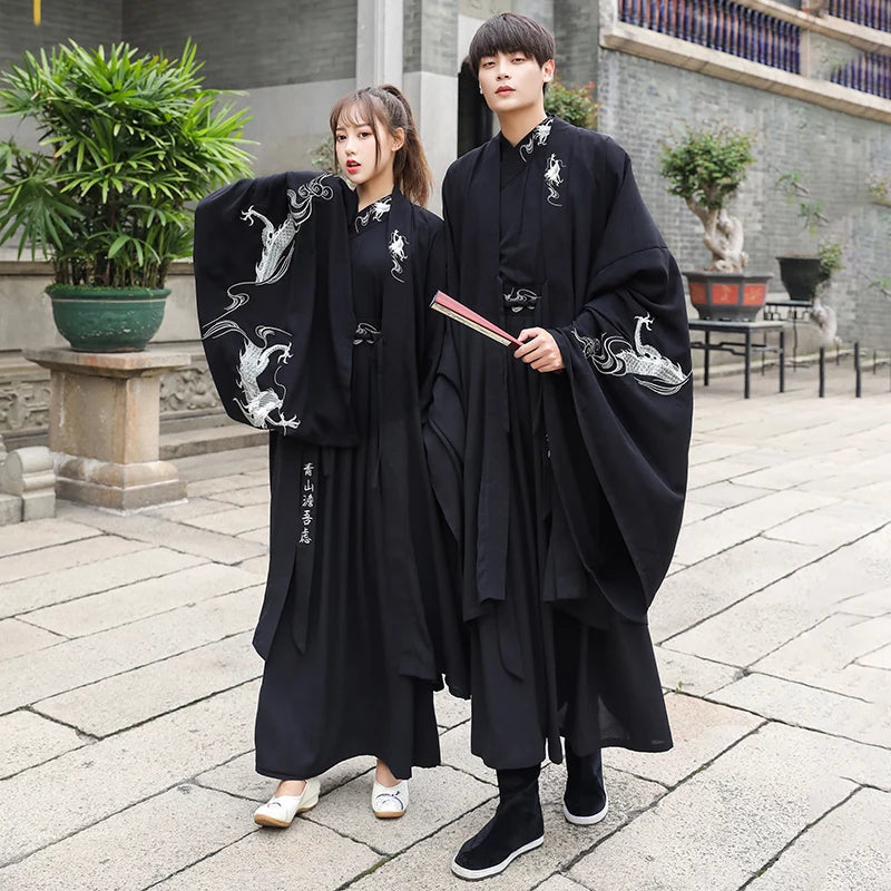 Han Dynasty couple costume featuring a swordsman outfit in black, showcasing intricate designs in a historic setting.