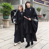 Han Dynasty couple costume featuring a swordsman outfit in black, showcasing intricate designs in a historic setting.
