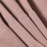 Close-up of ribbed fabric texture in a soft pink color, ideal for seamless camisoles and tank tops.