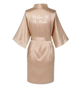 Rose gold satin robe with "Mother Of The Bride" text on the back, perfect for wedding preparation, plus size option.