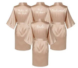 Rose gold satin bridal robes for bride, bridesmaid, maid of honor, and mother of the bride.