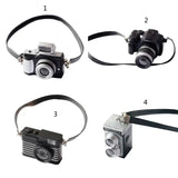 Mini camera collection for dollhouse, featuring various styles in black, perfect for baby photography props.