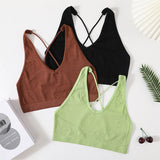 Three seamless crop tops in black, brown, and green, featuring a stylish, sexy design for women's streetwear fashion.