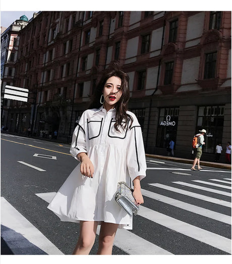 Maternity shirt dress in solid white color, featuring turn-down collar and pockets, ideal for summer outings or beach parties.