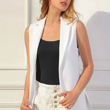 Woman wearing a white vest over a black tank top, showcasing a stylish and sophisticated summer outfit.
